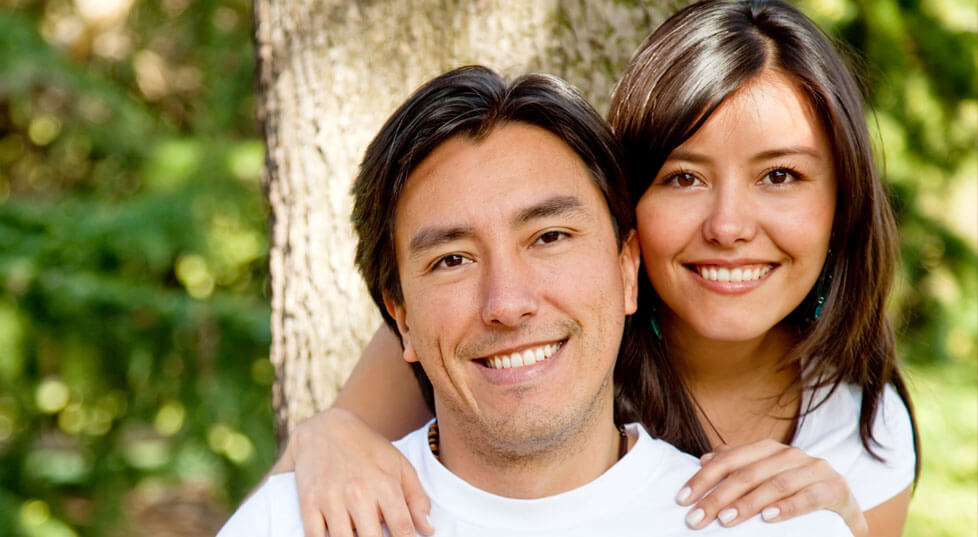 Smiling man and woman with gorgeous healthy teeth